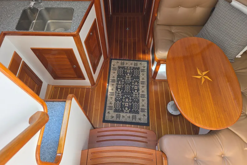 Slide: The Image of Interior of 2006 Bruckmann Bluestar 37 yacht with wooden flooring and elegant seating area. - 38