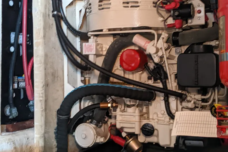 Slide: The Image of Engine compartment of a 2006 Bruckmann Bluestar 37 boat, showcasing mechanical components and wiring. - 37