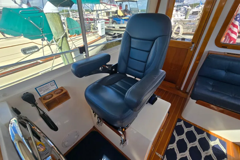 Slide: The Image of Captain's chair in 2006 Bruckmann Bluestar 37 yacht cockpit, with marina view. - 30