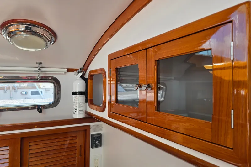 Slide: The Image of Interior of 2006 Bruckmann Bluestar 37 yacht with wooden cabinets and safety equipment. - 43
