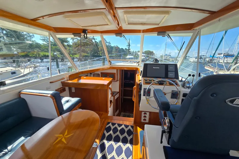 Slide: The Image of Interior of 2006 Bruckmann Bluestar 37 yacht with helm, seating, and wooden accents. - 21