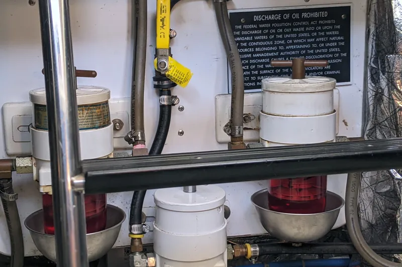 Slide: The Image of Engine room of 2006 Bruckmann Bluestar 37 with oil filters and discharge warning sign. - 36