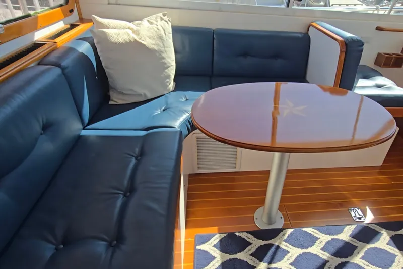 Slide: The Image of Luxurious interior of 2006 Bruckmann Bluestar 37 yacht with blue seating and wooden table. - 23