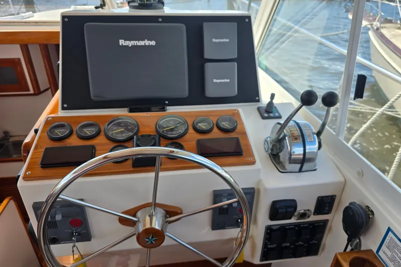 Slide: The Image of Helm of 2006 Bruckmann Bluestar 37 with Raymarine navigation and control instruments. - 26
