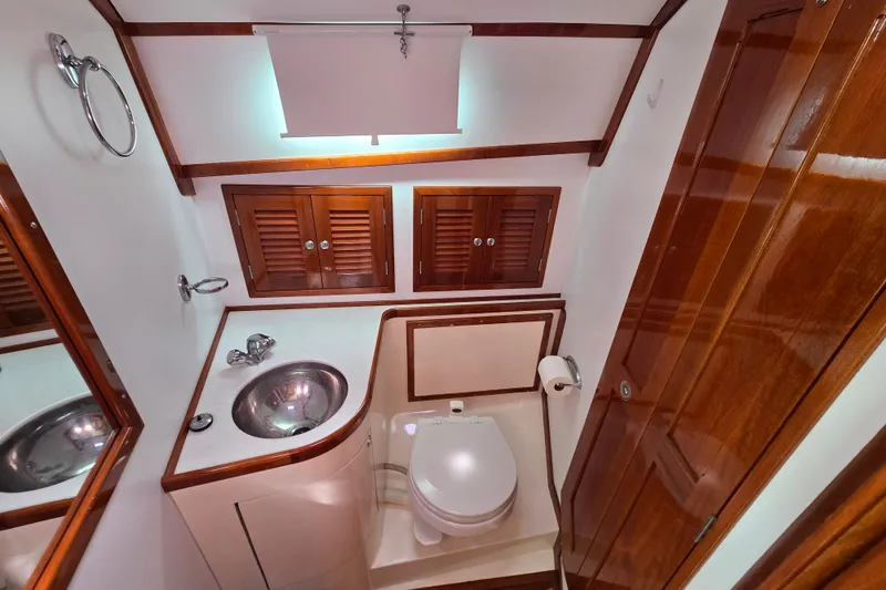 Slide: The Image of Luxurious bathroom in 2006 Bruckmann Bluestar 37 yacht with wooden accents and stainless steel sink. - 47