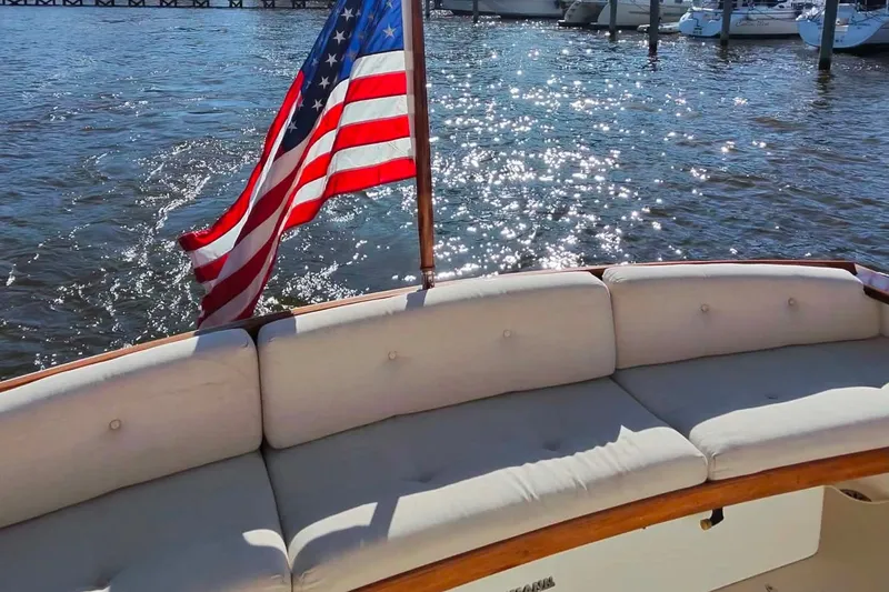 Slide: The Image of 2006 Bruckmann Bluestar 37 yacht with American flag, sparkling water backdrop. - 52