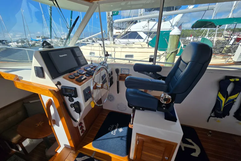 Slide: The Image of Helm of 2006 Bruckmann Bluestar 37 yacht with steering wheel and navigation equipment. - 32