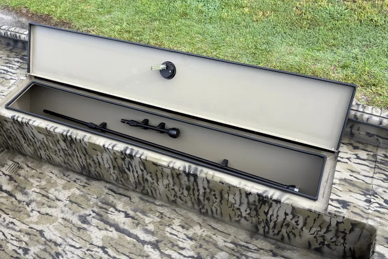 Slide: The Image of Open storage compartment on 2027 SeaArk Shadow 17 boat with camouflage design. - 11