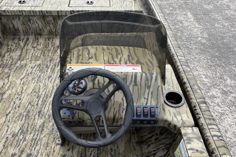 Slide: The Image of Steering console of 2027 SeaArk Shadow 17 boat with camouflage design. - 9