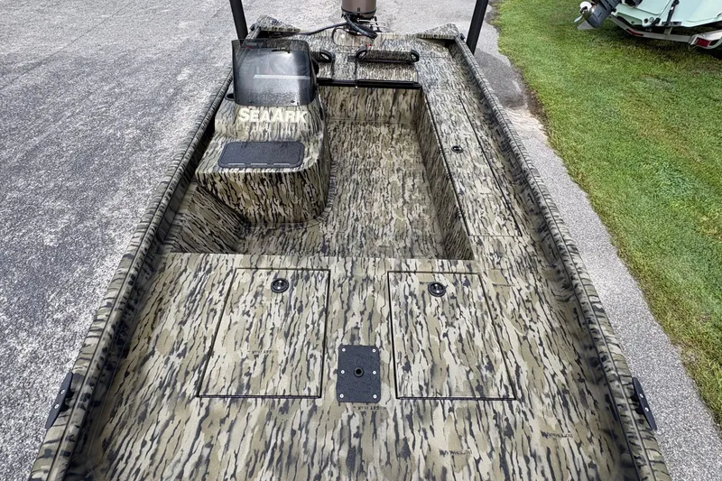 Slide: The Image of 2027 SeaArk Shadow 17 boat with camouflage design, featuring spacious interior and storage compartments. - 15