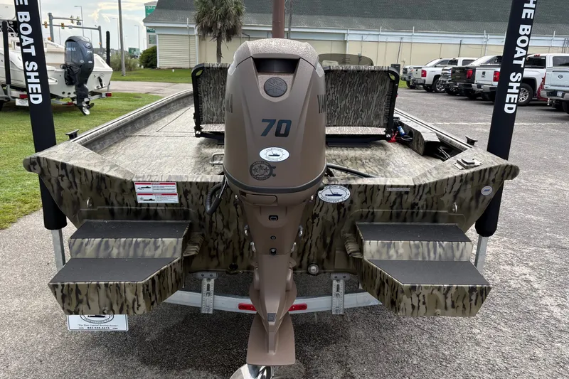Slide: The Image of 2027 SeaArk Shadow 17 boat with Yamaha 70 engine, parked at a dealership. - 2