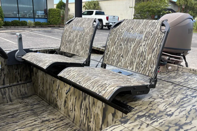 Slide: The Image of 2027 SeaArk Shadow 17 boat with camouflage seating and Yamaha motor in a parking lot. - 7