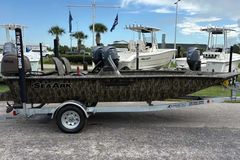 Slide: The Image of 2027 SeaArk Shadow 17 boat on trailer, camo design, Yamaha motor, outdoor display. - 3