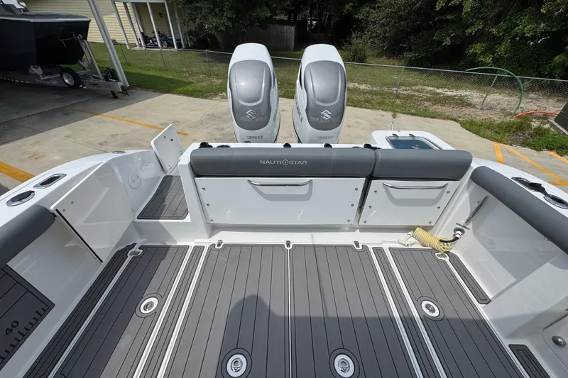 Slide: The Image of 2026 NauticStar 332 Offshore boat deck with dual Suzuki engines. - 46