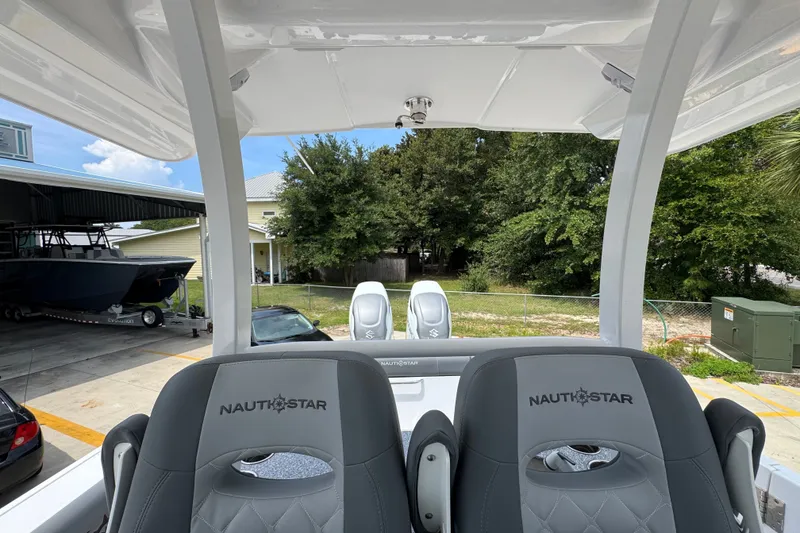 Slide: The Image of 2026 NauticStar 332 Offshore boat interior with branded seating and outdoor view. - 35
