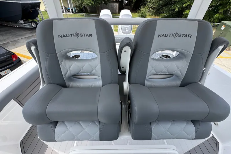Slide: The Image of 2026 NauticStar 332 Offshore boat seats, featuring gray upholstery and branded logo. - 34