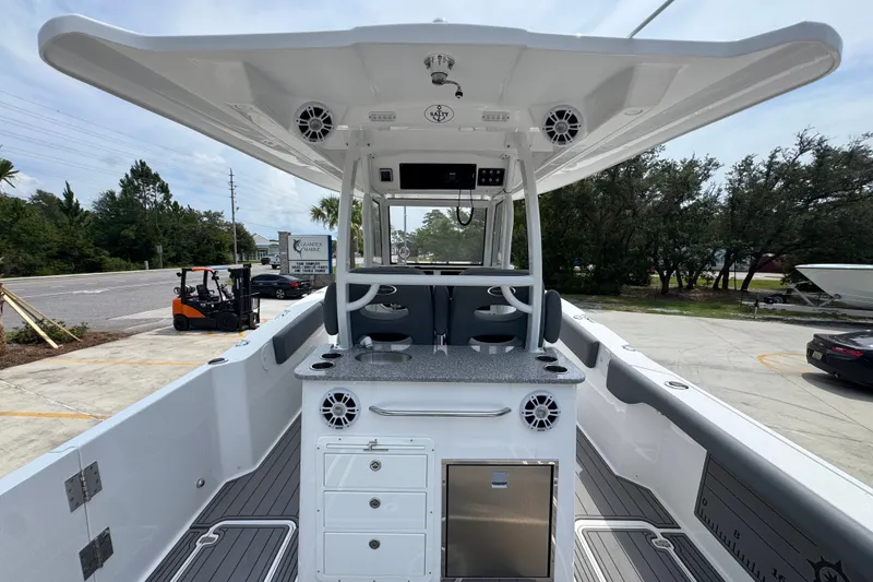 Slide: The Image of 2026 NauticStar 332 Offshore boat interior with modern helm and seating area. - 42