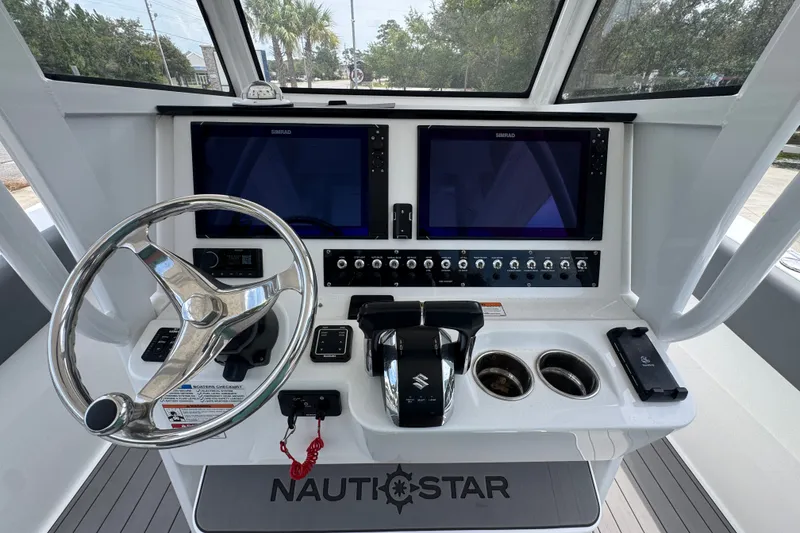 Slide: The Image of Helm of 2026 NauticStar 332 Offshore boat with dual screens and controls. - 38