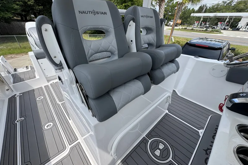 Slide: The Image of 2026 NauticStar 332 Offshore boat interior with luxurious gray seating and sleek flooring design. - 36