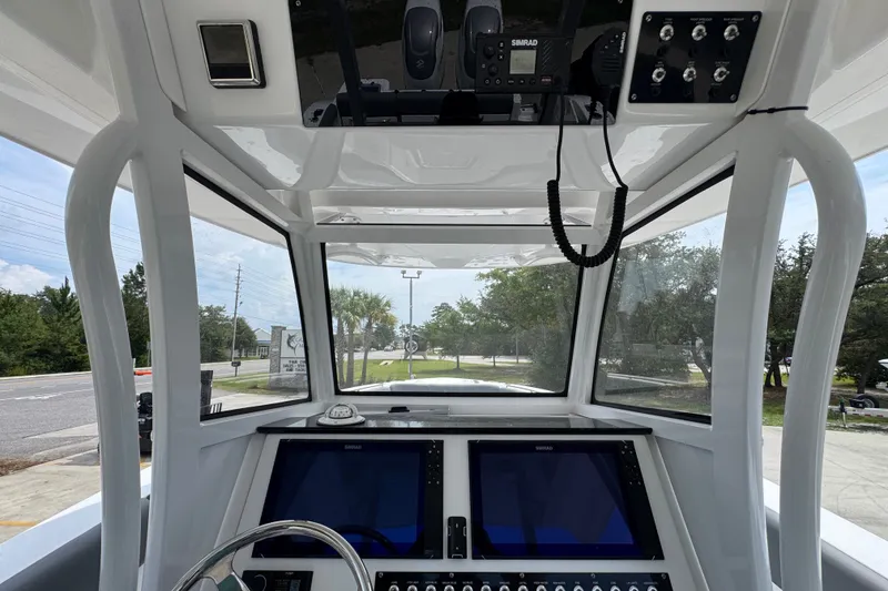 Slide: The Image of Interior view of 2026 NauticStar 332 Offshore boat cockpit with advanced navigation systems. - 39