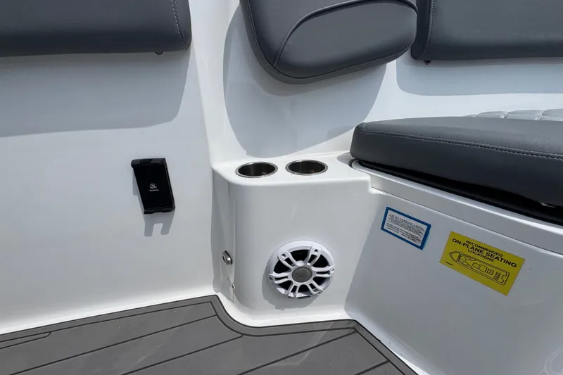 Slide: The Image of 2026 NauticStar 332 Offshore boat interior with cup holders and speaker. - 28