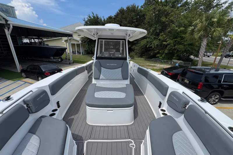 Slide: The Image of 2026 NauticStar 332 Offshore boat interior with gray seating and modern design. - 25