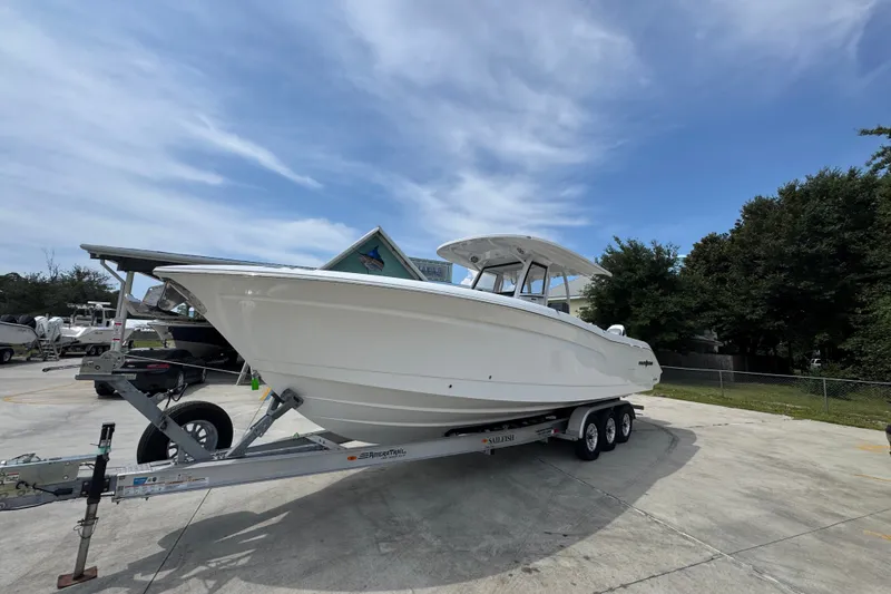 Slide: The Image of 2026 NauticStar 332 Offshore boat on trailer under clear sky. - 4