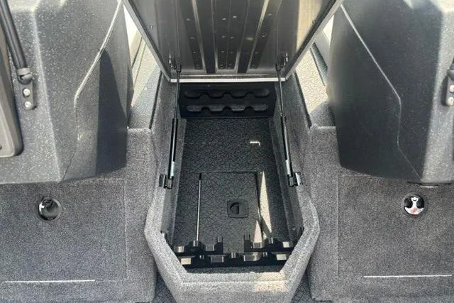 Slide: The Image of 2027 Tracker Pro Guide V-175 Combo boat storage compartment with open lid, showcasing interior space. - 15