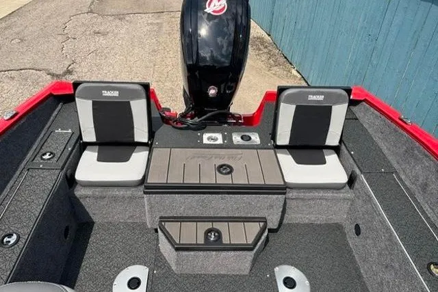 Slide: The Image of 2027 Tracker Pro Guide V-175 Combo boat interior with seating and motor, featuring a sleek design. - 28