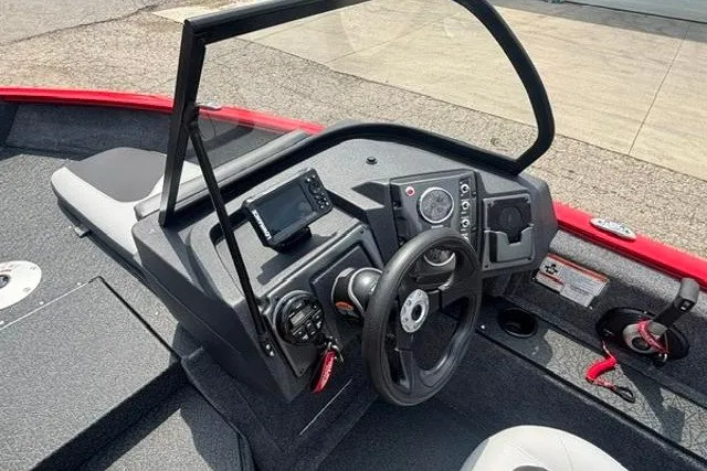 Slide: The Image of 2027 Tracker Pro Guide V-175 Combo boat dashboard with steering wheel and controls. - 16
