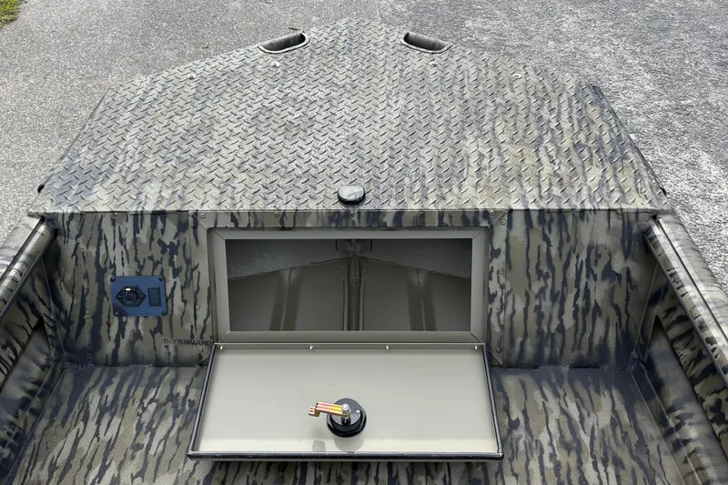 Slide: The Image of Camouflage-patterned SeaArk DXS 1652 DKLD boat with open storage compartment, 2027 model. - 13