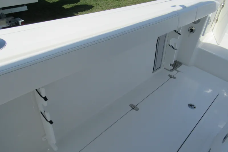 Slide: The Image of 2027 Parker 274 Fathom boat interior, featuring sleek white seating and storage compartments. - 23