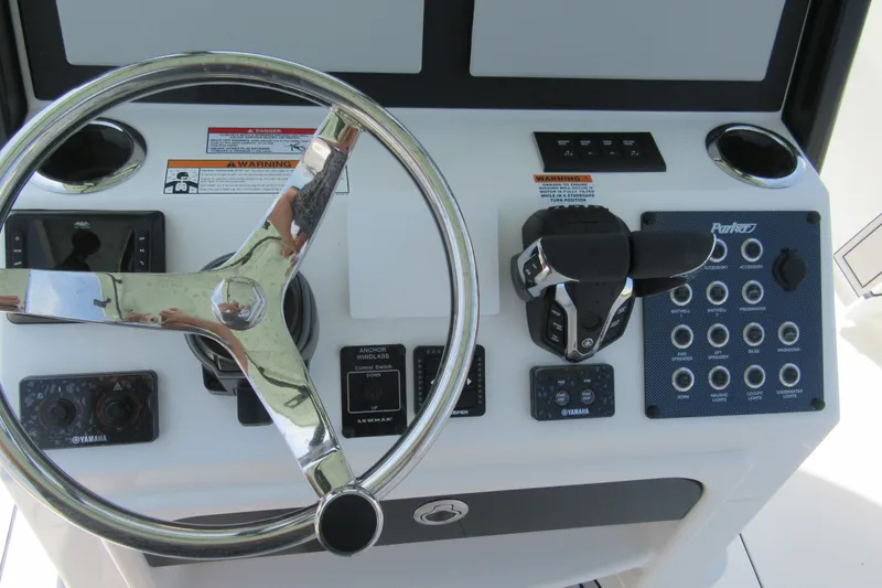 Slide: The Image of Steering console of 2027 Parker 274 Fathom boat with controls and gauges. - 16