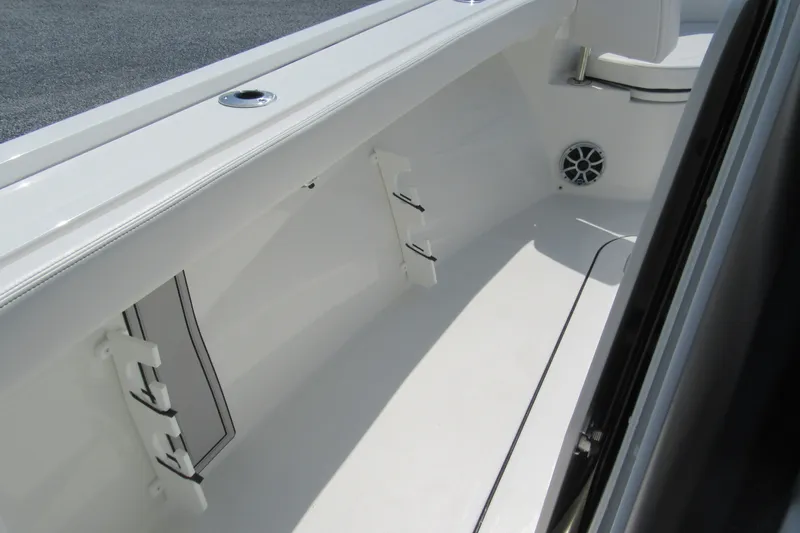 Slide: The Image of Interior view of 2027 Parker 274 Fathom boat, featuring sleek white design and storage compartments. - 22