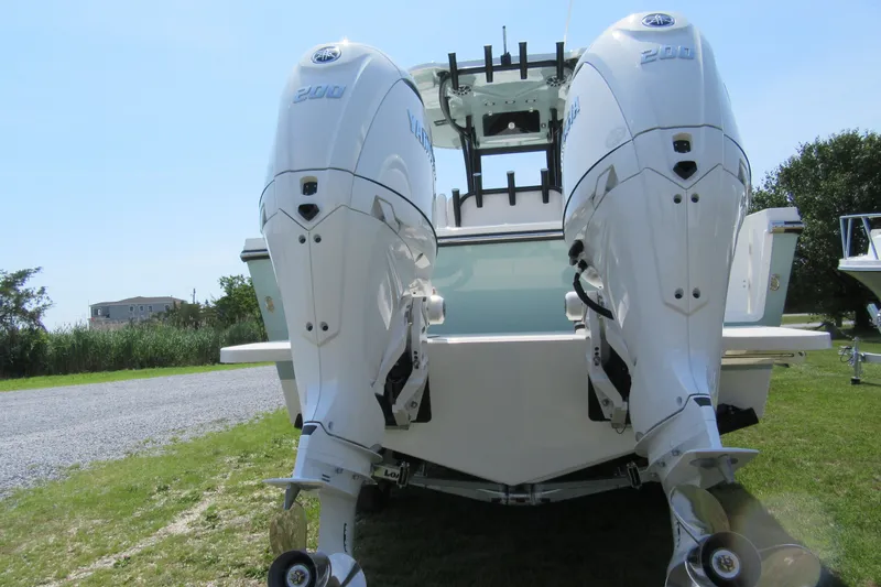 Slide: The Image of Parker 274 Fathom 2027 boat with dual Yamaha 200 engines, displayed outdoors. - 36