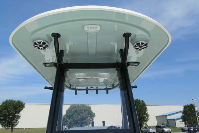 Slide: The Image of T-top view of 2027 Parker 274 Fathom boat with speakers and clear sky background. - 27