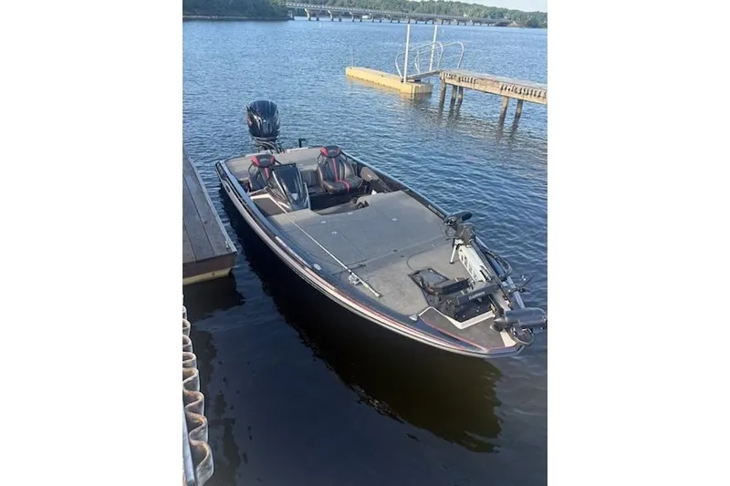 Slide: The Image of 2026 Skeeter ZXE20 boat docked on a calm lake with scenic background. - 9