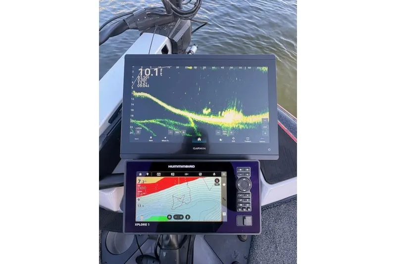 Slide: The Image of Fishfinder and navigation screens on a 2026 Skeeter ZXE20 boat dashboard. - 20