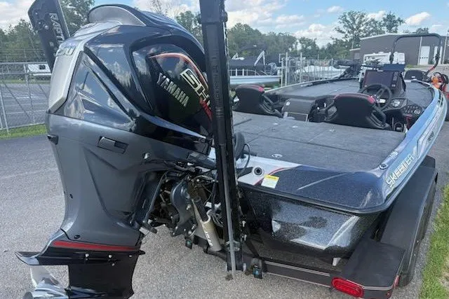 Slide: The Image of 2026 Skeeter ZXE20 boat with Yamaha engine, parked outdoors on a sunny day. - 2