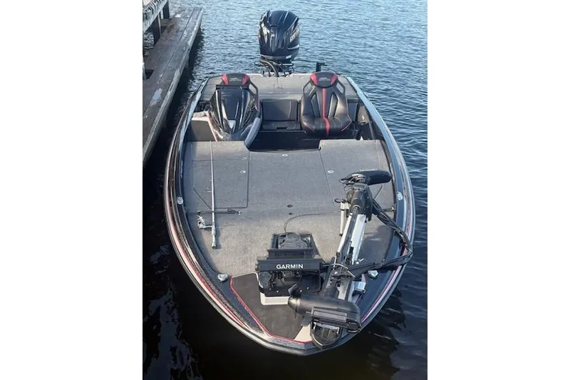 Slide: The Image of 2026 Skeeter ZXE20 fishing boat with Garmin equipment on calm water. - 12