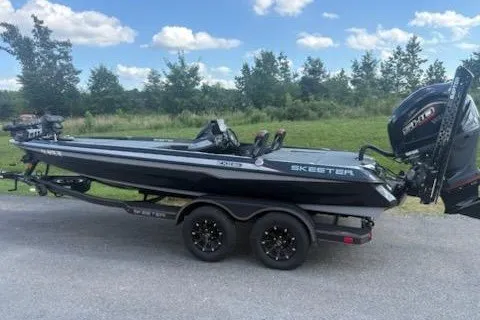 Slide: The Image of 2026 Skeeter ZXE20 boat on trailer, black with sleek design, parked outdoors. - 1