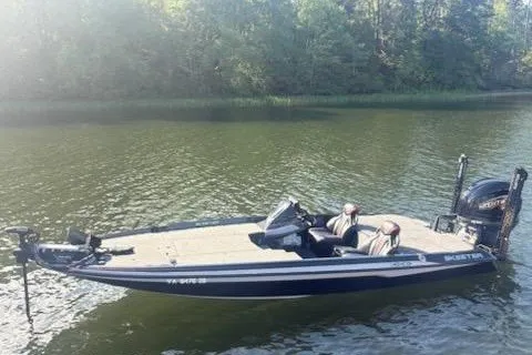 Slide: The Image of 2026 Skeeter ZXE20 boat on calm lake with forested background. - 17