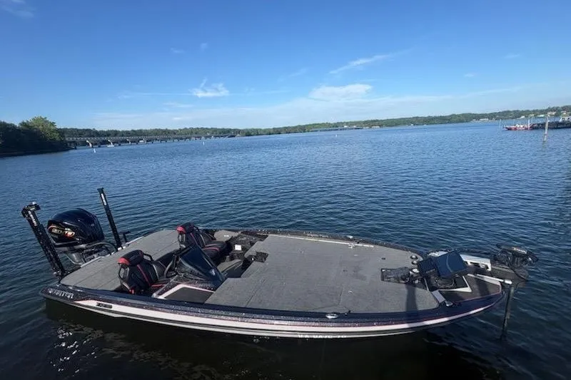 Slide: The Image of 2026 Skeeter ZXE20 boat on a calm lake under a clear blue sky. - 7