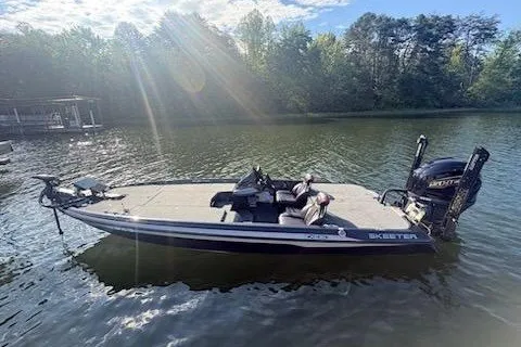 Slide: The Image of 2026 Skeeter ZXE20 boat on a serene lake with trees in the background. - 14