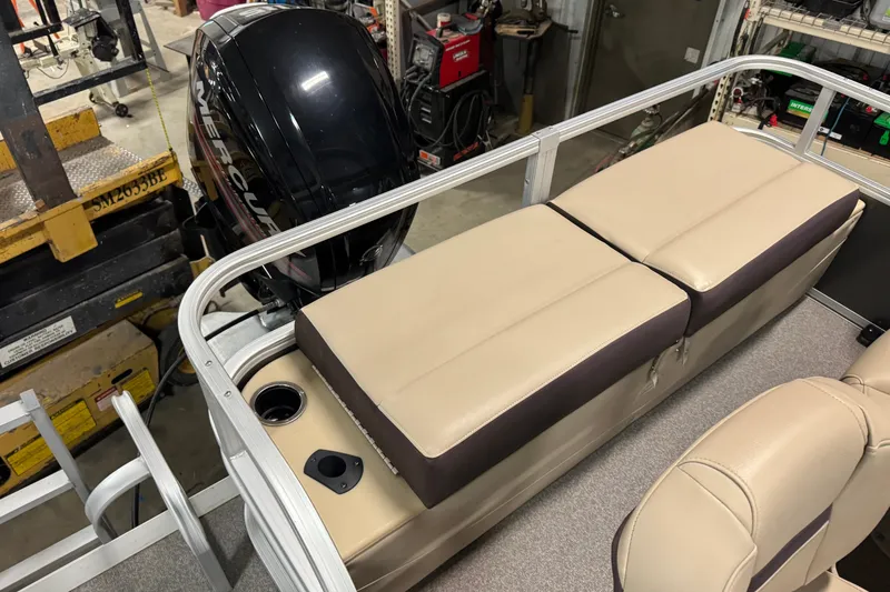 Slide: The Image of 2018 Sun Tracker SportFish 22 DLX boat interior with beige seating and Mercury outboard motor. - 14