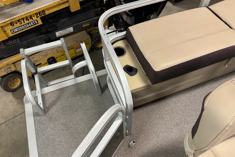 Slide: The Image of 2018 Sun Tracker SportFish 22 DLX boat interior with beige seating and metal railing. - 13