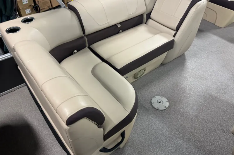 Slide: The Image of 2018 Sun Tracker SportFish 22 DLX boat interior with beige seating and cup holders. - 15