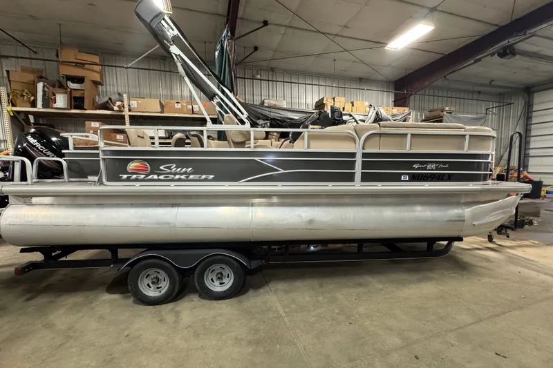 The Image of 2018 Sun Tracker SportFish 22 DLX pontoon boat in a storage facility. - 0
