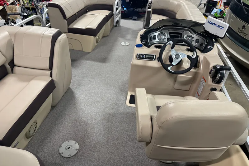 Slide: The Image of 2018 Sun Tracker SportFish 22 DLX interior with beige seating and modern dashboard. - 16