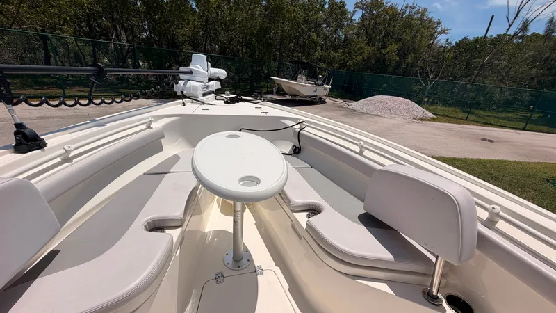Slide: The Image of The image shows the bow of a Mako 214CC boat with seating and a round table. - 14